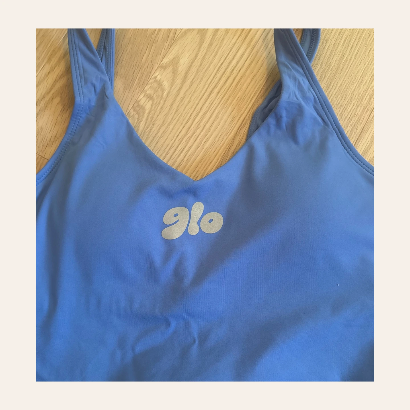Blue sports bra with reflective GLO logo